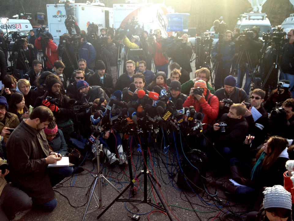 Reporters await a press briefing in Newtown, Conn.