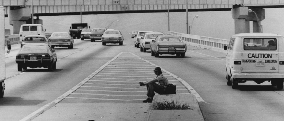An Orlando man tries hitch-hiking back home from I-95 and 395 cutoff in 1979.