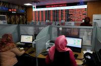 Women work at Khartoum Stock Exchange in Khartoum