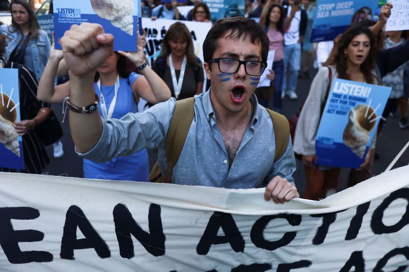 Activists take part in the 'Blue Climate March' outside the UN Ocean Conference in Lisbon to urge world leaders to act and protect the environment, in Lisbon