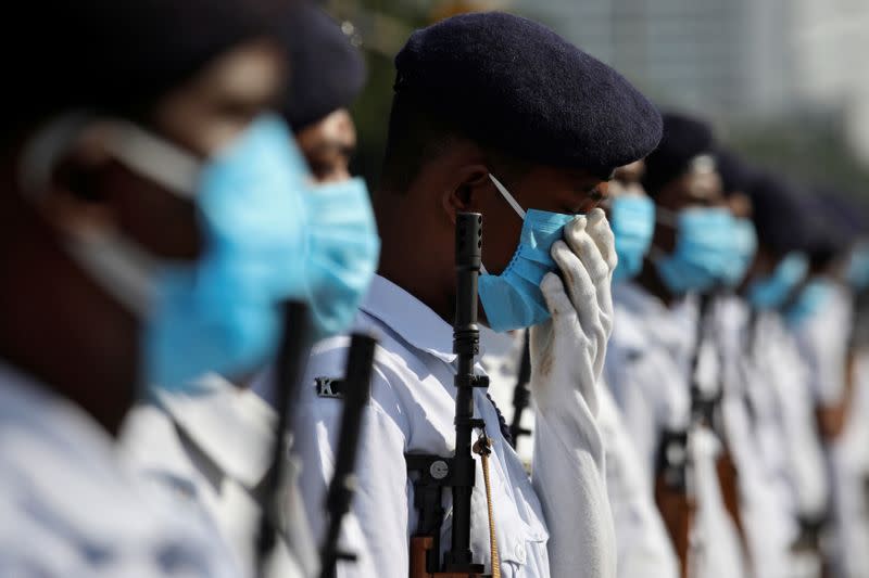 A member of Kolkata police adjusts his face mask as he takes part in rehearsal for the Independence Day parade, after authorities eased lockdown restrictions that were imposed to slow the spread of the coronavirus disease, in Kolkata