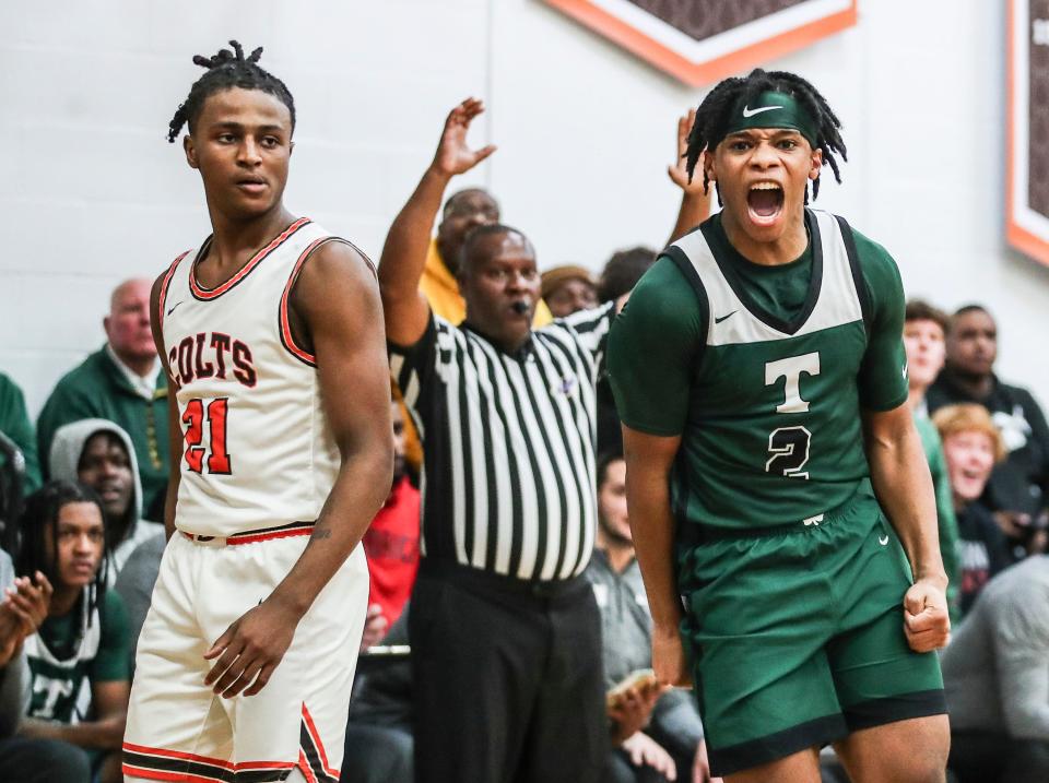 As DeSale's Damone King (21) looks on, Trinity's Dre Vassar celebrates after scoring in the second half. Vassar had 40 points and led all scorers as the Rocks win over the Colts 75-71 at DeSales High School. Nov. 28, 2023