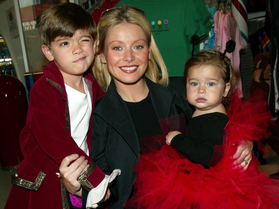 Kelly Ripa with son Michael and daughter Lola at a Halloween party to benefit New York Weill Cornell Medical Center's Big Apple Circus Clown Care Unit at Dylan's Candy Bar in New York City. October 20, 2002.