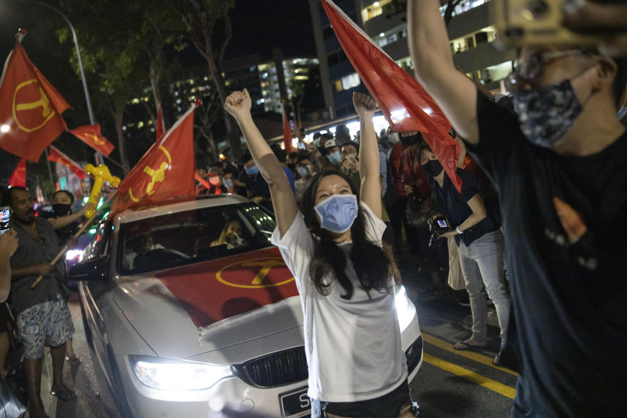 Supporters of the Workers' Party cheering at Hougang Avenue 5 in the early hours of 11 July, 2020 after the results of the general election were announced. The party won 10 seats in the House in its strongest showing to-date. (PHOTO: Don Wong for Yahoo News Singapore)