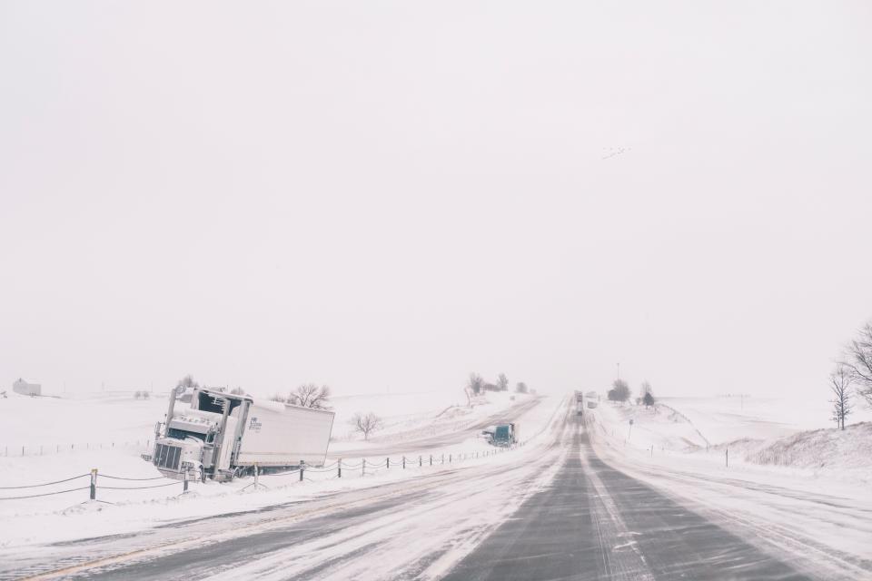 crashed semi trucks sit abandoned along Interstate 80 in central Iowa on Saturday, Jan. 13, 2024. Heavy snow and high winds led the National weather service to issue a blizzard warning for much of the state of Iowa. (Nick Rohlman /The Gazette via AP) ORG XMIT: IACED607
