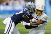 Los Angeles Chargers running back Austin Ekeler, right, is tackled by Dallas Cowboys safety Jayron Kearse during the first half of an NFL football game Sunday, Sept. 19, 2021, in Inglewood, Calif. (AP Photo/Gregory Bull )