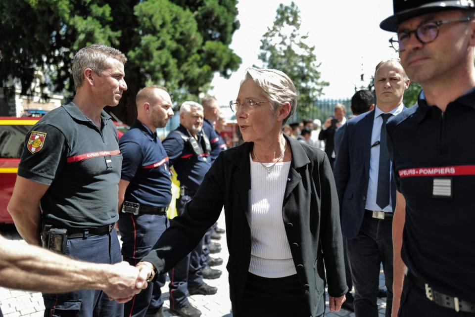 French Prime Minister Elisabeth Borne (C) in Annecy French Alps, after a stabbing attack in a the city's 'Jardins de l'Europe' parc (AFP via Getty Images)