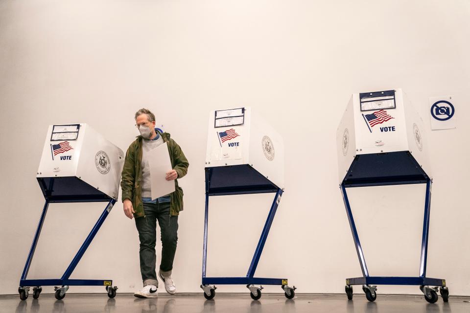 A voter moves to cast their vote after filling out their ballot at a polling site inside The Shed arts center, Tuesday, Nov. 8, 2022, in the Hudson Yards neighborhood of the Manhattan borough of New York. (AP Photo/John Minchillo) ORG XMIT: NYJM125