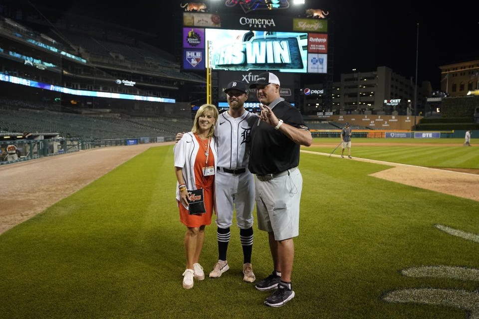 Roger Clemens, seven-time Cy Young Award winning pitcher, right and his wife Debbie pose with their son, Kody Clemens, after the second baseball game of a doubleheader against the Minnesota Twins, Tuesday, May 31, 2022, in Detroit. Kody made his debut with the Tigers in the major leagues. (AP Photo/Carlos Osorio)