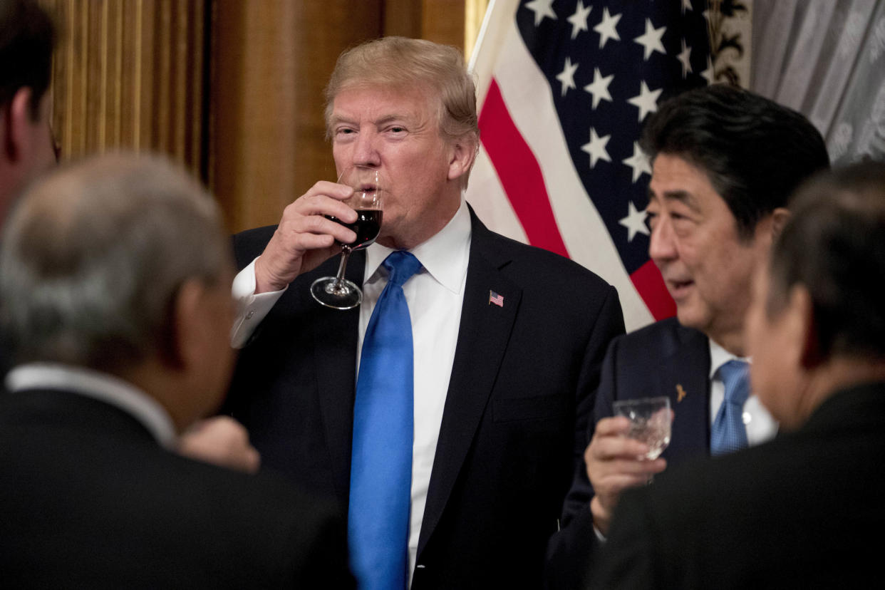 US President Donald Trump and Japanese Prime Minister Shinzo Abe, right, share a drink after toasting each other during a state banquet at the Akasaka Palace (AP Photo/Andrew Harnik): AP