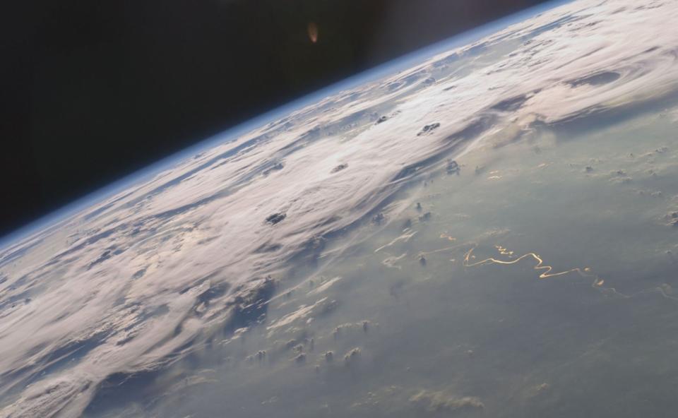 A picturesque line of thunderstorms and numerous circular cloud patterns filled the view as the International Space Station (ISS) Expedition 20 crew members looked out at the limb (blue line on the horizon) of the Earth. The region shown in the astronaut photograph (top image) includes an unstable, active atmosphere forming a large area of cumulonimbus clouds in various stages of development. The crew was looking west-southwest from the Amazon Basin, along the Rio Madeira toward Bolivia when the image was taken.