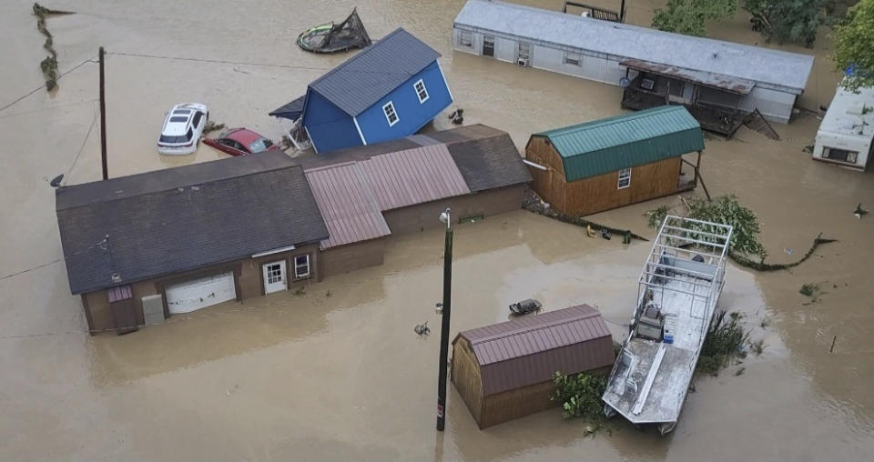 Vehicles and buildings are sit in floodwaters following heavy rains Monday, Aug. 28, 2023, in Chesapeake W.Va. (Bob Aaron/WCHS-TV via AP)