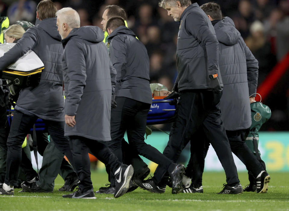 Luton Town's Tom Lockyer is taken from the field by medical staff, during the English Premier League soccer match between Bournemouth and Luton Town at the Vitality Stadium,in Bournemouth, England, Saturday, Dec. 16, 2023. (Steven Paston/PA via AP)