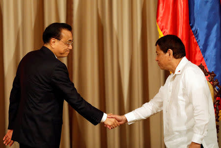 Chinese Premier Li Keqiang shakes hands with President Rodrigo Duterte at Malacanang Palace in metro Manila, Philippines November 15, 2017. REUTERS/Dondi Tawatao