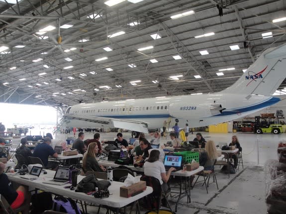 Teams of students and teachers prepare their experiments for weightless tests inside a NASA hangar at Ellington Field in Houston during NASA's Microgravity University Program flight week on July 17, 2013. Fourteen teams were selected to fly exp