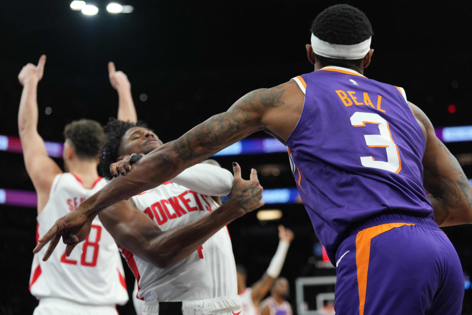 Phoenix Suns guard Bradley Beal (3) pushes Houston Rockets guard Jalen Green (4) during the second half at Footprint Center in Phoenix on March 2, 2024.
