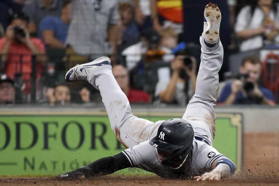 New York Yankees' Gleyber Torres slides past home plate to score during the seventh inning of a baseball game against the Houston Astros, Sunday, July 11, 2021, in Houston. (AP Photo/Eric Christian Smith)