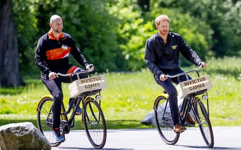 The Duke of Sussex (R) makes a bike ride with Dutch athlete Dennis Van Der Stroom (L)  - Credit: &nbsp;REX