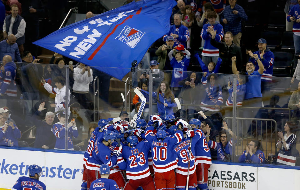 FILE - The New York Rangers and fans celebrate a shootout victory over the New York Islanders in an NHL hockey game April 13, 2024, in New York. As the NHL playoffs begins this weekend, ushering in the most exciting hockey of the year, business is booming and the league has bounced back in a big way from the pandemic. (AP Photo/John Munson, File)