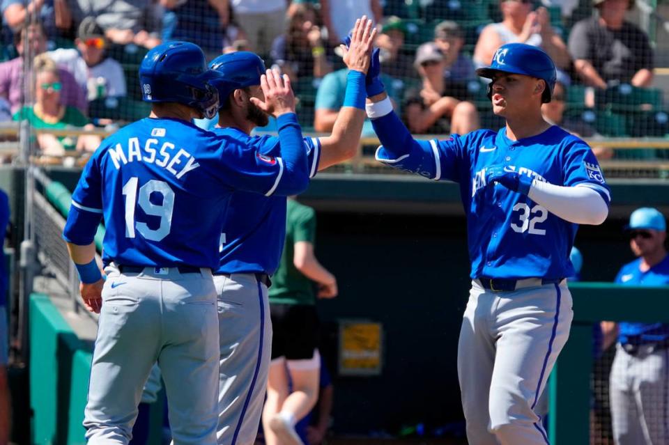 Kansas City Royals first baseman Nick Pratto (32) celebrates with catcher Austin Nola (14) and second baseman Michael Massey (19) after hitting a three-run home run against the Oakland Athletics in the second inning at Hohokam Stadium on March 10, 2024.