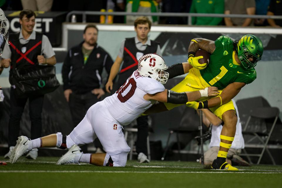 Oregon inside linebacker Noah Sewell carries the ball after recovering a fumble as the No. 13 Oregon Ducks take on the Stanford Cardinal Saturday, Oct. 1, 2022, at Autzen Stadium in Eugene, Ore. 