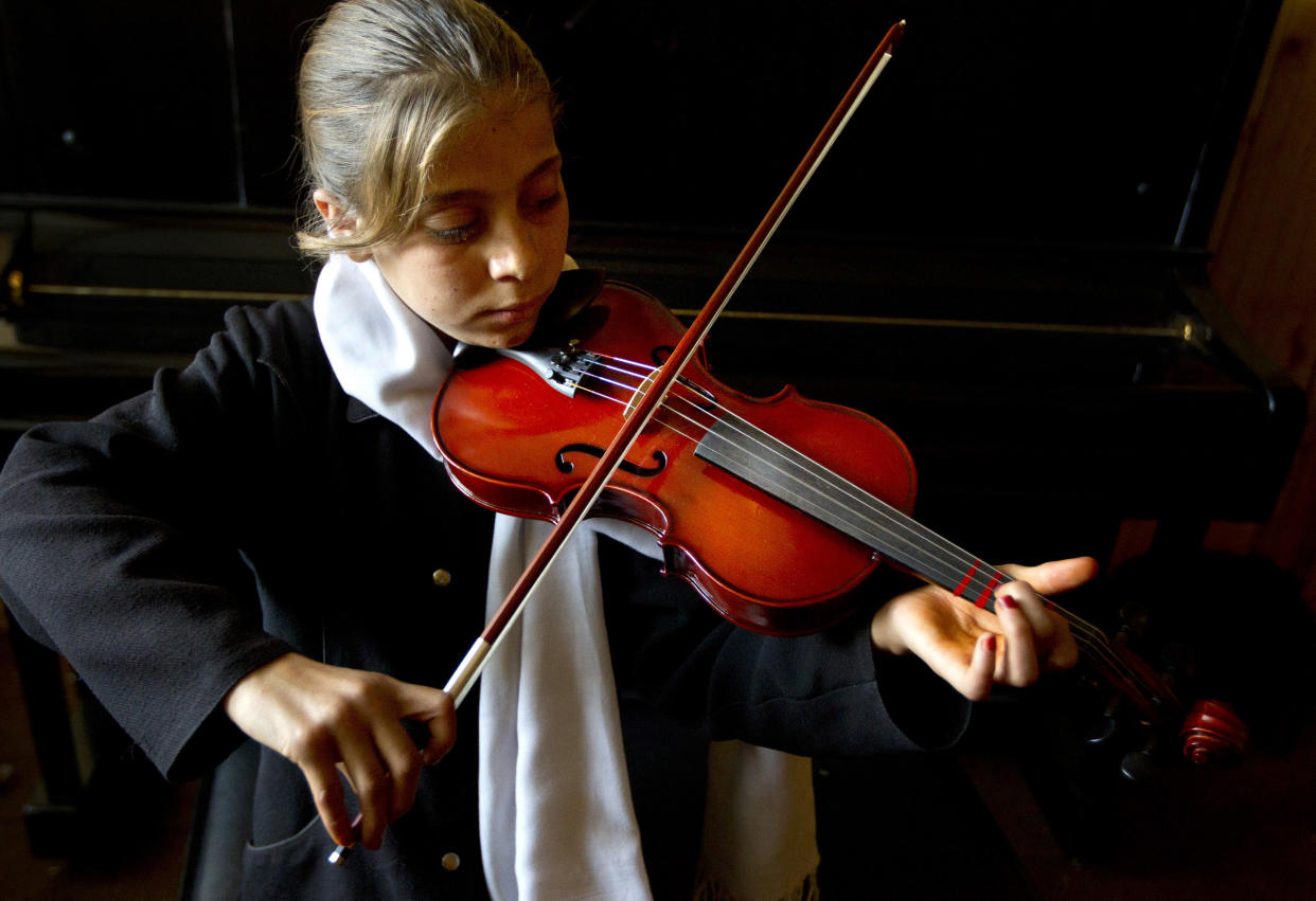 Marjan Fidaye,11, practices during violin lessons at the Afghanistan National Institute of Music on September 26, 2010 in Kabul, Afghanistan. (Paula Bronstein /Getty Images)