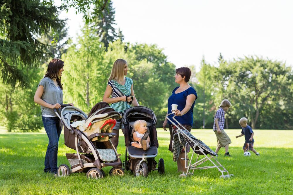 moms with strollers in park