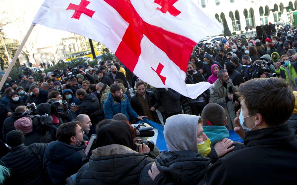 Georgian opposition supporters attend a rally following the detention of the United National Movement party leader Nika Melia - AP