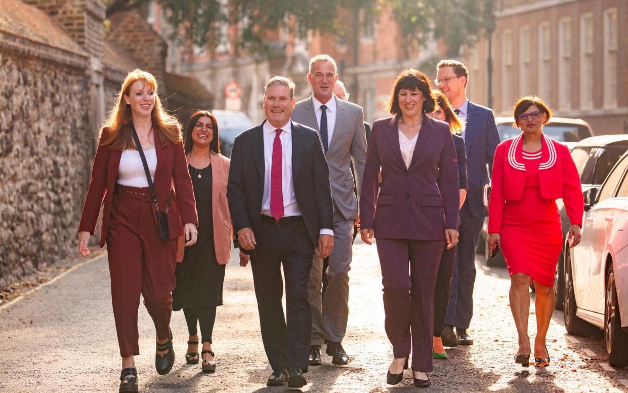 Labour's shadow cabinet walk outdoors towards the camera with golden evening light behind them, in September 2023
