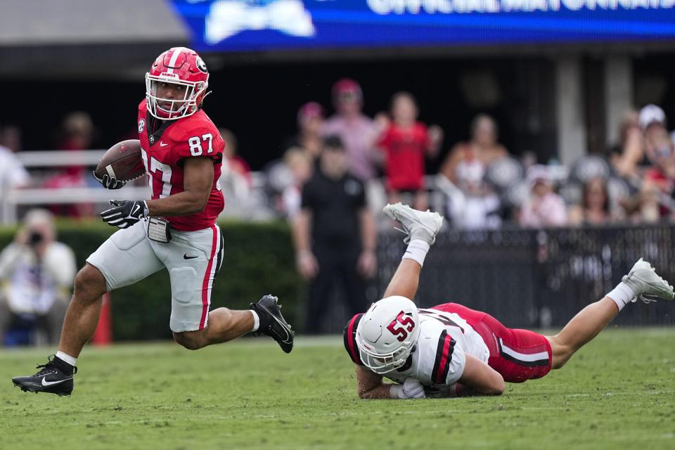 Georgia's Mekhi Mews (87) runs past Ball State's Dalton Elrod (55) as he returns a punt for a touchdown in the first half of an NCAA college football game Saturday, Sept. 9, 2023, in Athens, Ga. (AP Photo/John Bazemore)