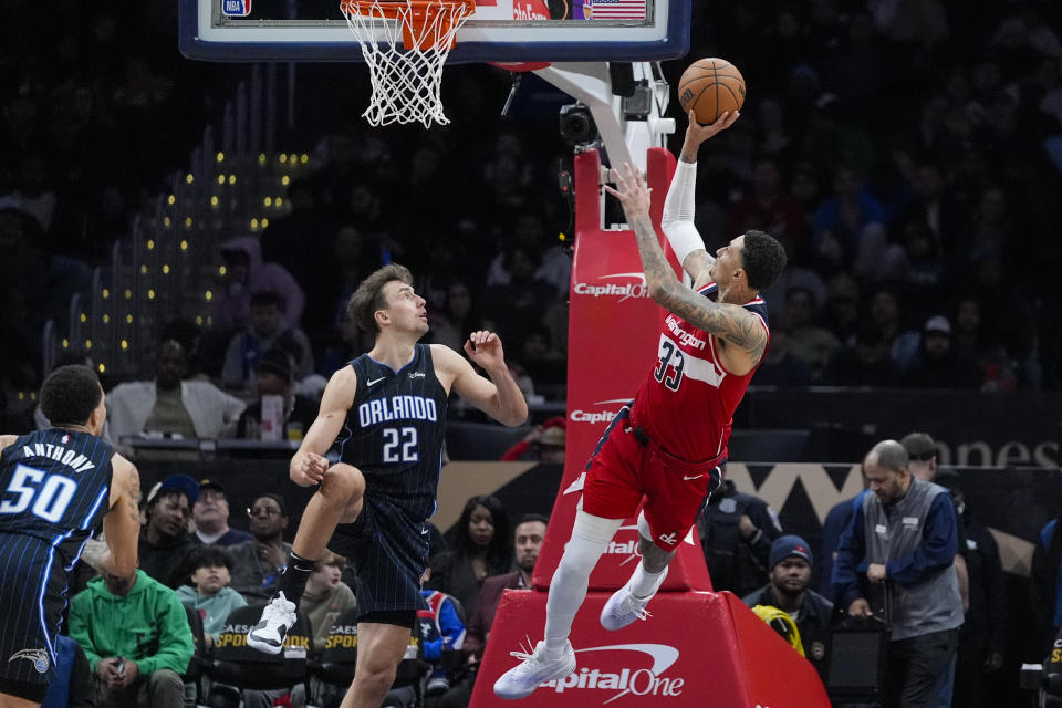 Washington Wizards forward Kyle Kuzma (33) shoots in front of Orlando Magic forward Franz Wagner (22) during the second half of an NBA basketball game Wednesday, March 6, 2024, in Washington. The Magic won 119-109. (AP Photo/Alex Brandon)