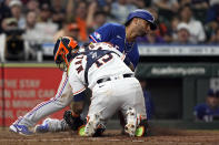 Texas Rangers' Ezequiel Duran, rear, is tagged out at home plate by Houston Astros catcher Martin Maldonado (15) during the seventh inning of a baseball game Wednesday, Aug. 10, 2022, in Houston. (AP Photo/David J. Phillip)