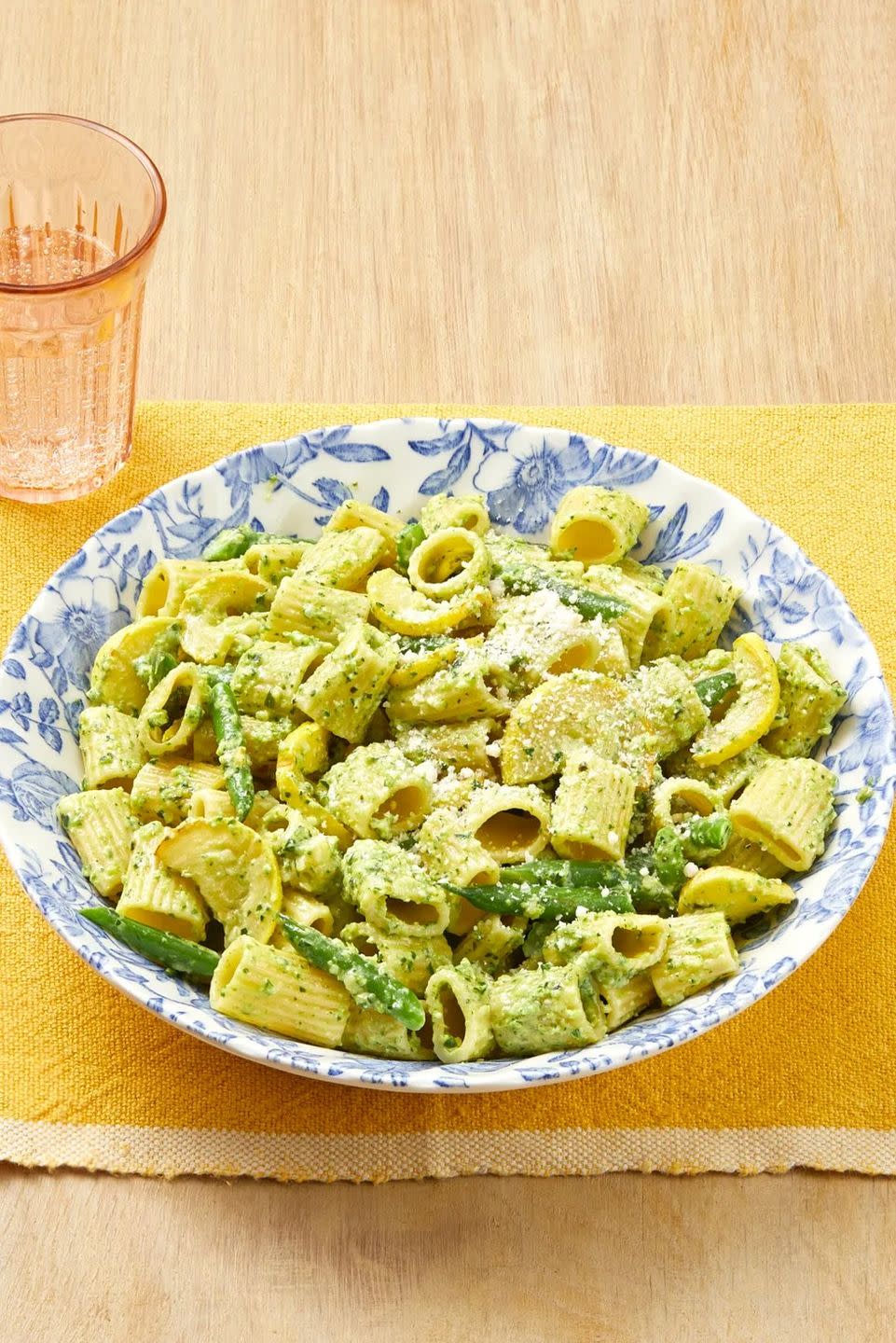 pasta with zucchini pesto in blue bowl