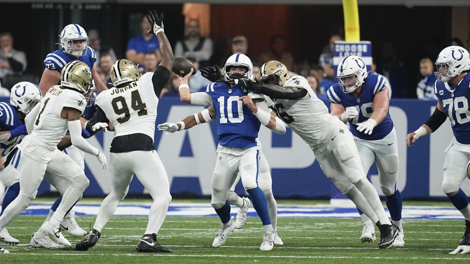 Indianapolis Colts quarterback Gardner Minshew (10) throws under pressure from the New Orleans Saints during the second half of an NFL football game Sunday, Oct. 29, 2023 in Indianapolis. (AP Photo/Darron Cummings)