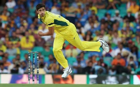 Australian bowler Mitchell Starc follows through with a delivery during his Cricket World Cup semi-final match against India in Sydney, March 26, 2015. REUTERS/Steve Christo