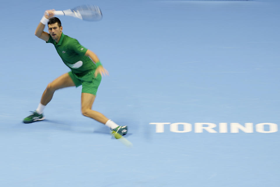 In this photo taken with slow shutter speed, Serbia's Novak Djokovic returns the ball to Russia's Andrej Rublev during their singles tennis match of the ATP World Tour Finals, at the Pala Alpitour in Turin, Italy, Wednesday, Nov. 16, 2022. (AP Photo/Antonio Calanni)