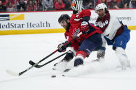 Colorado Avalanche defenseman Samuel Girard (49) defends against Washington Capitals right wing Tom Wilson (43) during the first period of an NHL hockey game Tuesday, Oct. 19, 2021, in Washington. (AP Photo/Alex Brandon)