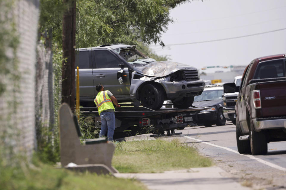 Emergency personnel take away a damaged vehicle after a fatal collision in Brownsville, Texas, on May 7, 2023. (Michael Gonzalez / AP)