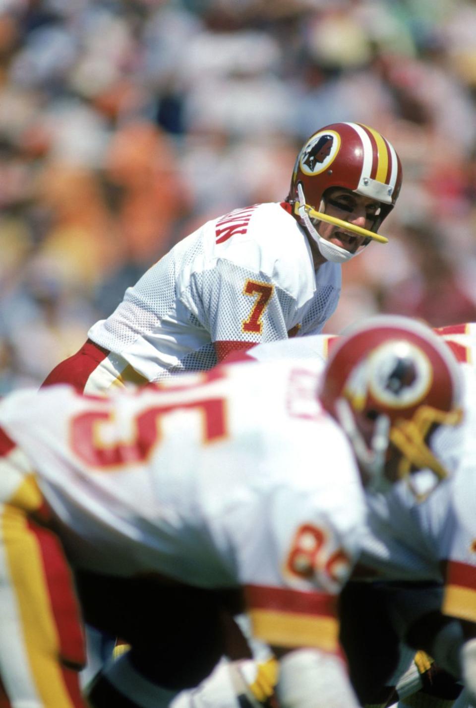 Washington Redskins quarterback Joe Theismann at the line of scrimmage.