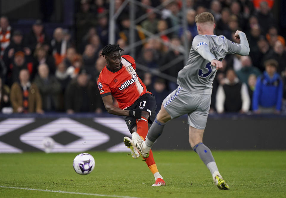Luton Town's Elijah Adebayo, left, scores during the English Premier League soccer match between Luton Town and Everton at Kenilworth Road, Luton, Friday May 3, 2024. (Bradley Collyer/PA via AP)