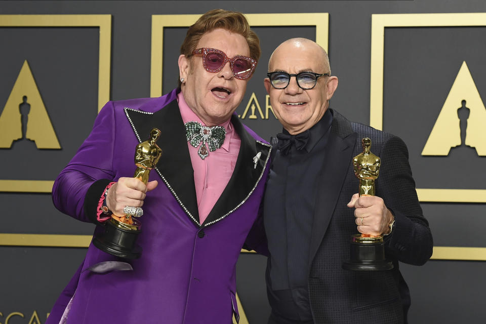 Elton John, left, and Bernie Taupin, winners of the award for best original song for "(I'm Gonna) Love Me Again" from "Rocketman", pose in the press room at the Oscars on Sunday, Feb. 9, 2020, at the Dolby Theatre in Los Angeles. (Photo by Jordan Strauss/Invision/AP)