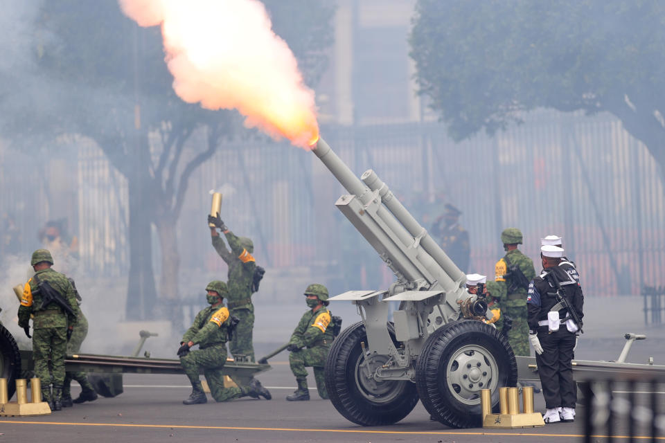 VARIOUS CITIES, MEXICO - SEPTEMBER 16: Soldiers fire a ceremonial artillery salute during the Independence Day military parade at Zocalo Square on September 16, 2020 in Various Cities, Mexico. This year El Zocalo remains closed for general public due to coronavirus restrictions. Every September 16 Mexico celebrates the beginning of the revolution uprising of 1810. (Photo by Hector Vivas/Getty Images)