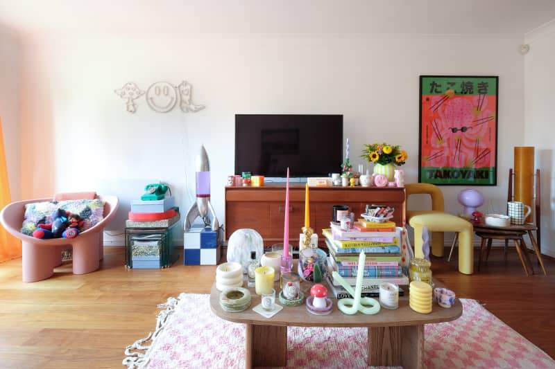 View of white living room with colorful accessories.