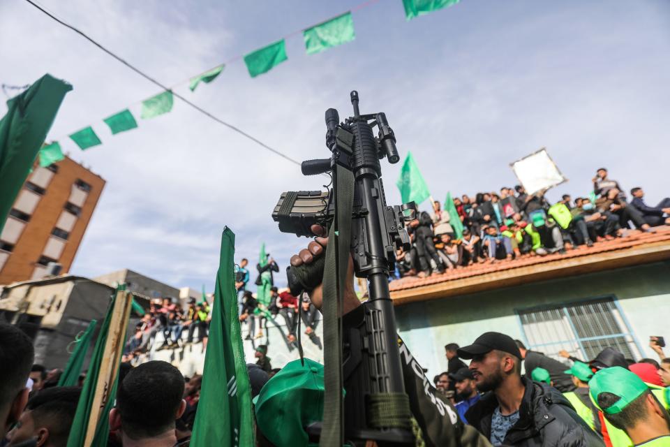 A Palestinian supporter of Hamas carries M16 machine gun in Jabalya Refugee camp northern Gaza strip, in 2021.