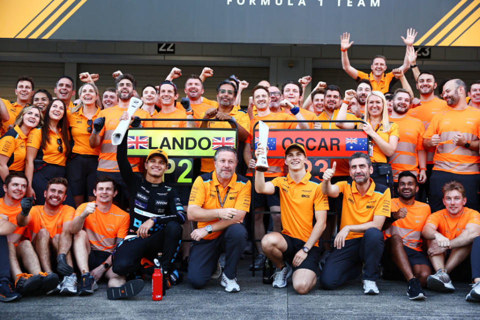 SUZUKA, JAPAN - SEPTEMBER 24: Second placed Lando Norris of Great Britain and McLaren, Third placed Oscar Piastri of Australia and McLaren, McLaren Chief Executive Officer Zak Brown and the McLaren team pose for a photo as they celebrate after the F1 Grand Prix of Japan at Suzuka International Racing Course on September 24, 2023 in Suzuka, Japan. (Photo by Clive Rose/Getty Images)