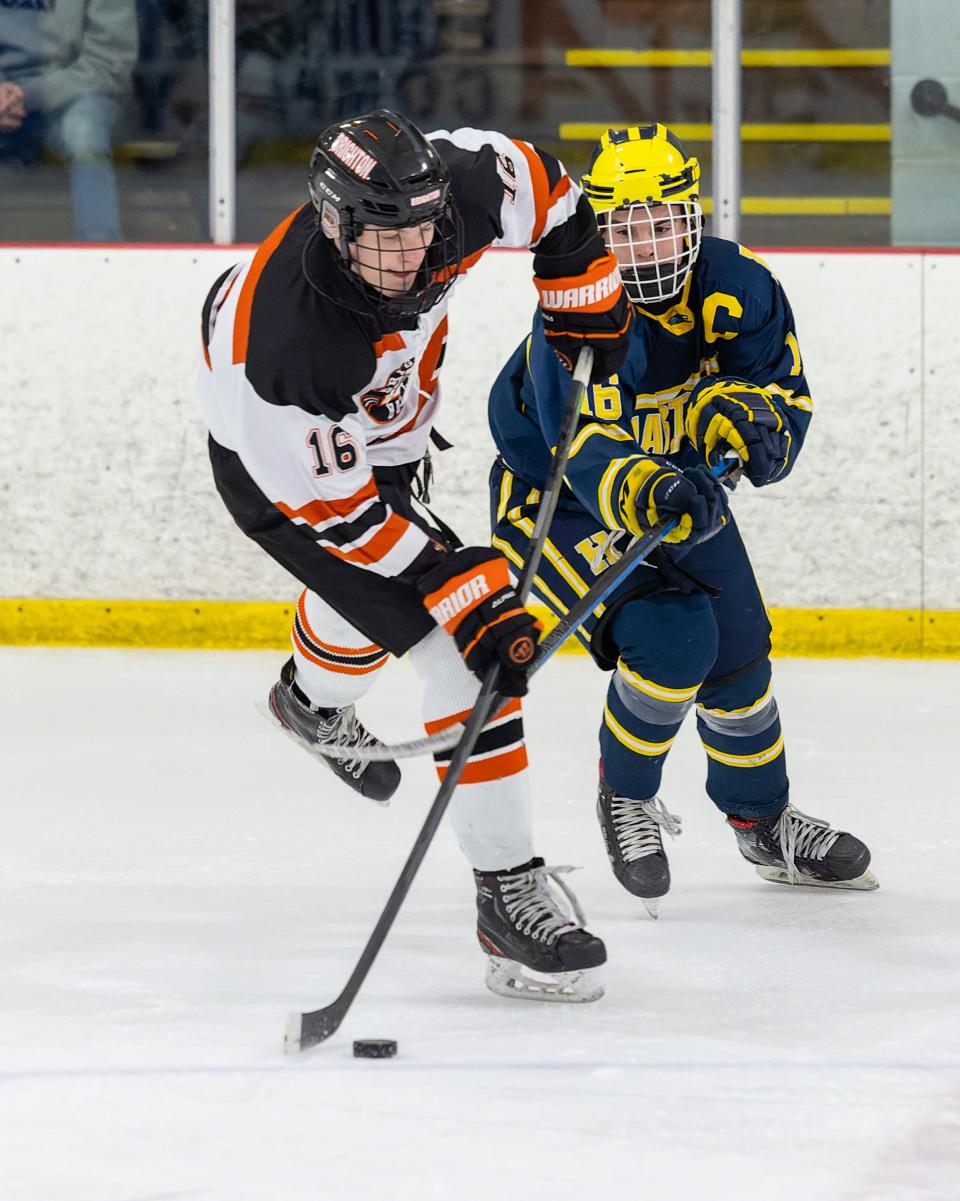 Brighton's Cam Duffany handles the puck while defendd by Hartland's Ashton Trombley on Saturday, Jan. 15, 2022 at Kensington Valley Ice House.