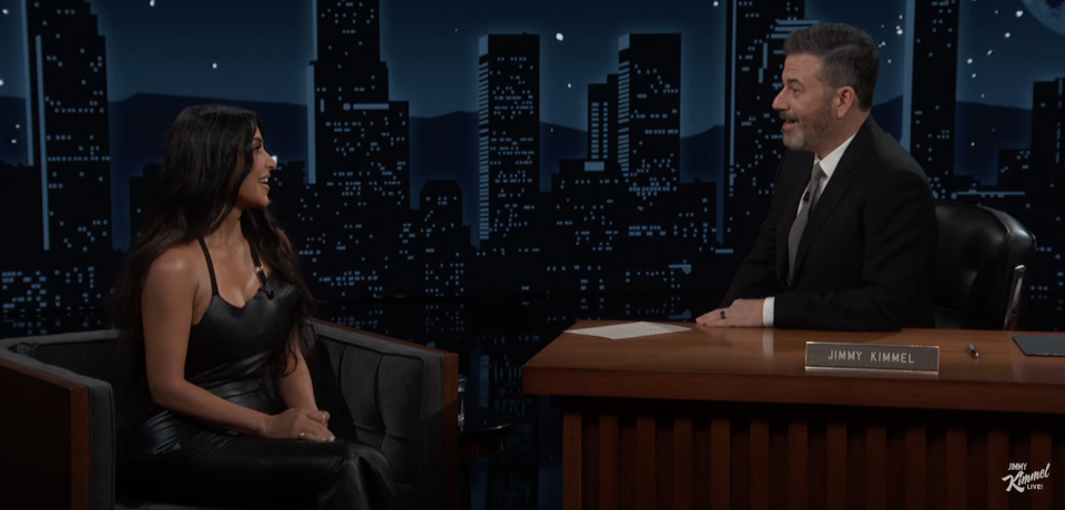 Kim Kardashian in a black dress on Jimmy Kimmel Live, both seated, engaged in conversation