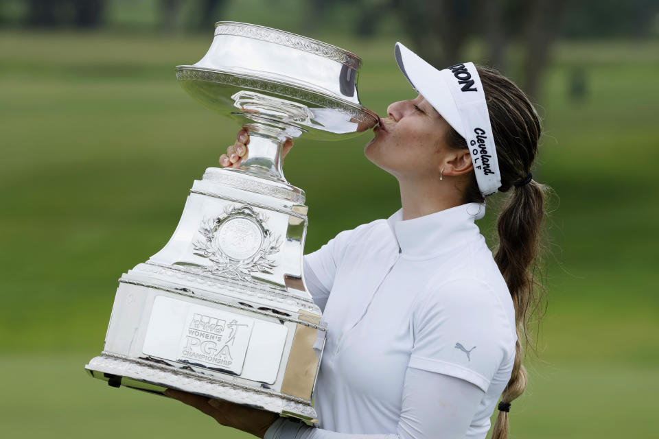 Hannah Green, of Australia, kisses the trophy after winning the KPMG Women's PGA Championship golf tournament, Sunday, June 23, 2019, in Chaska, Minn. (AP Photo/Charlie Neibergall)