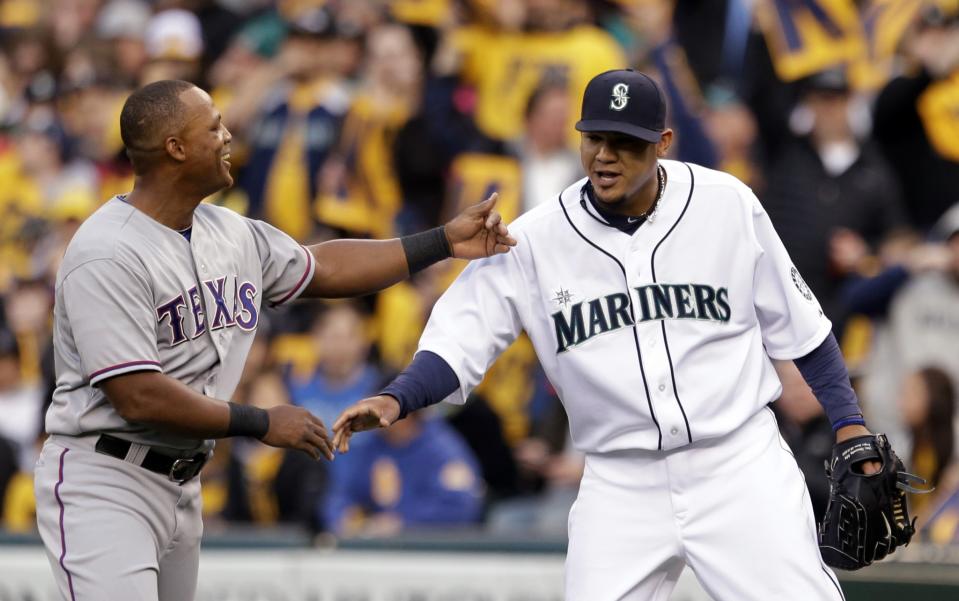 Texas Rangers' Adrian Beltre, left, congratulates Seattle Mariners starting pitcher Felix Hernandez on Hernandez's 1,500th career strikeout in the first inning of a baseball game on Thursday, April 11, 2013, in Seattle.