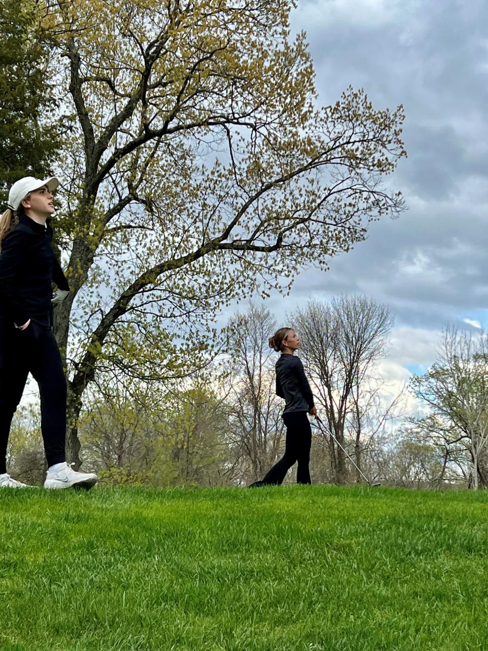 Arlington's Caelyn Deserre looks on as Wappingers' Kayla Kinkel swings during the Mid-Hudson Regional girls golf tournament on April 25, 2023.